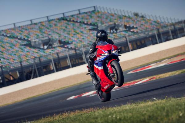 A motorcycle pulling a wheelie on a racing track