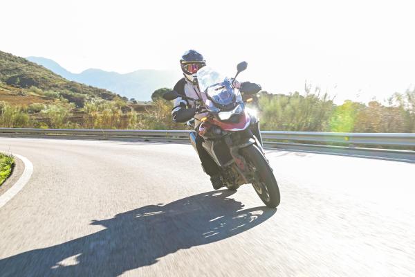 A motorcycle being ridden along a mountain road