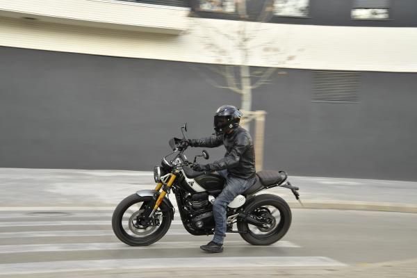 A motorbike being ridden in a city centre