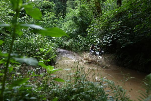 a motorcycle being ridden through deep water