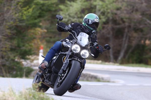 A motorcycle being along a canyon road