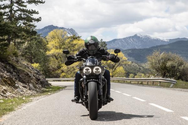 A motorcycle being along a canyon road