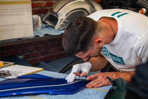 Bodywork being hand-painted at BMW Motorrad Days