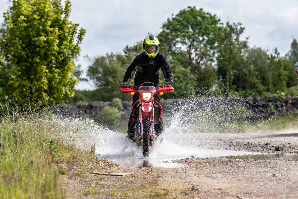 A Honda CRF250L splashing through water