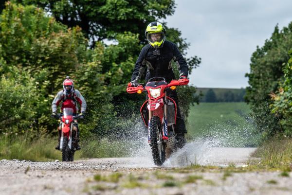 Two trail bikes on a green lane