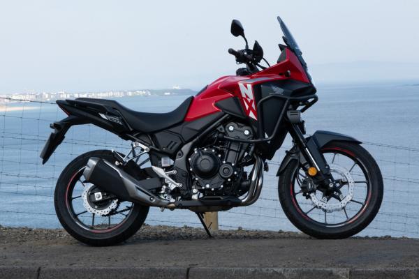 a Honda motorcycle parked in front of the sea