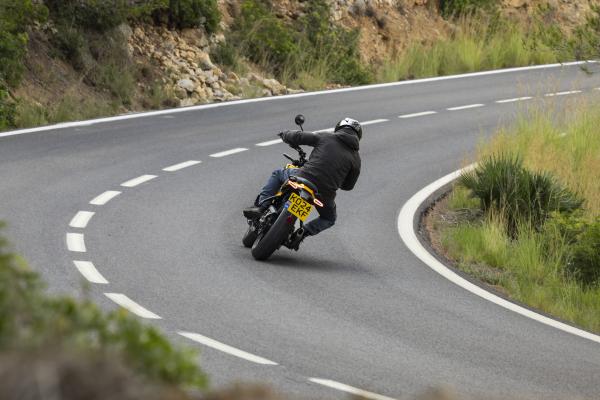 A motorcycle being ridden on a winding road