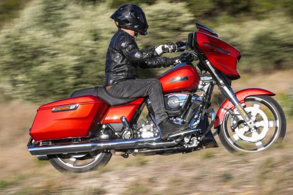 A Harley-Davidson being ridden along a road