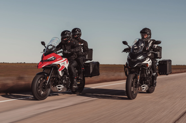 Two adventure motorcycles riding along a road